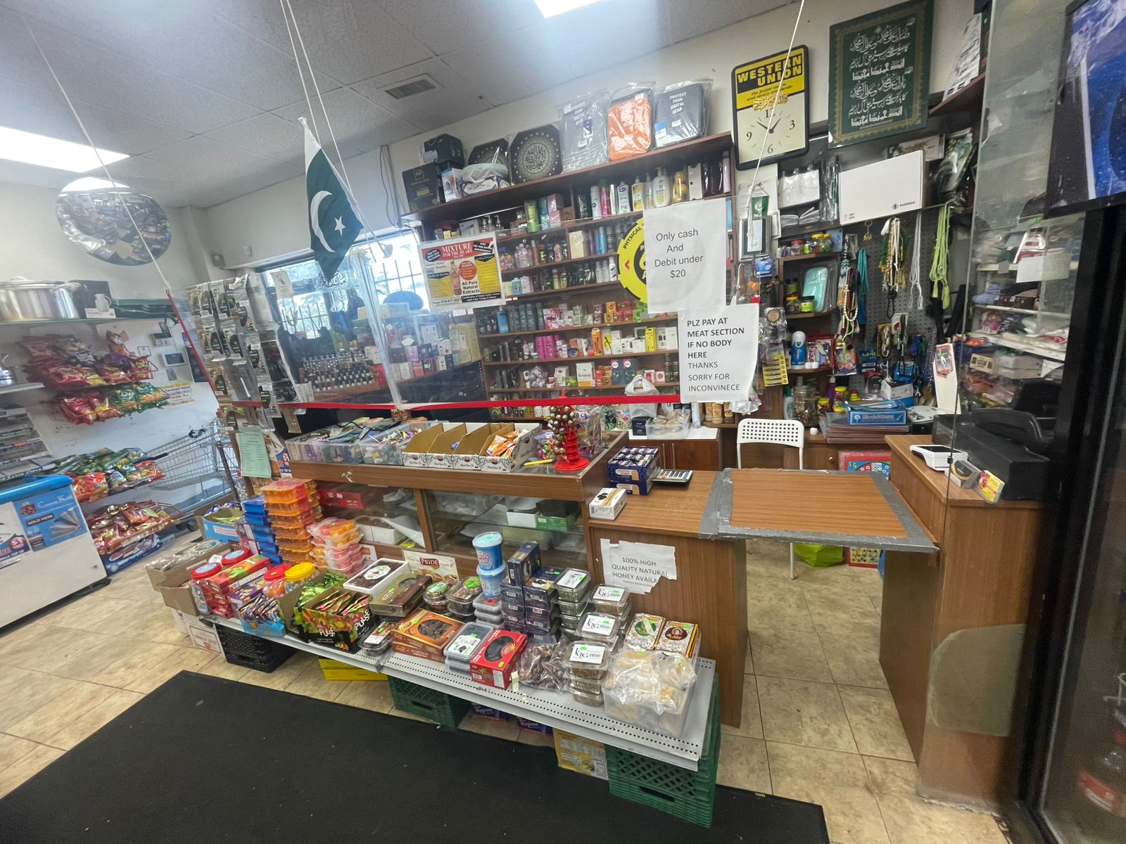 Checkout counter with dates, honey and Islamic items at Al-Khair Halal Meat & Grocery Mississauga